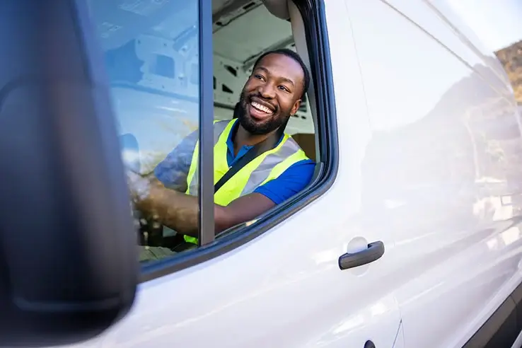 smiling man driving van