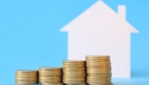house graphic with coins stacked up