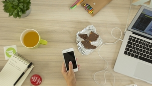 desk scene with iphone and mac