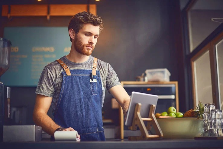 café owner using digital tablet