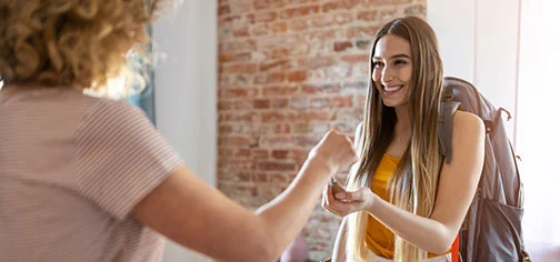 estate agent giving woman keys.