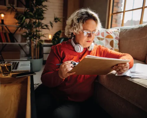 woman reading documents in a home office