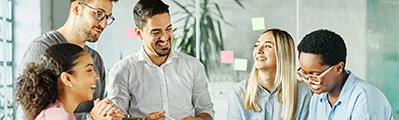 a group of smiling business people having a meeting in an office