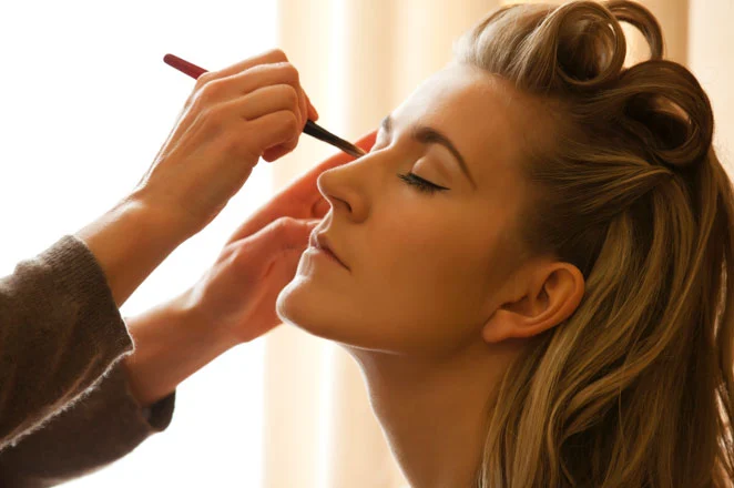 a woman having her make-up done professionally