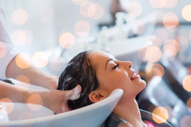 a woman having her hair washed in a salon