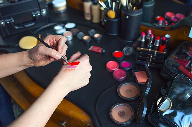 a make-up artist testing colours on the back of her hand